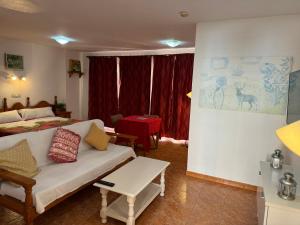 a living room with a couch and a bed at Apartamentos Turísticos Yamasol in Fuengirola +37 photos