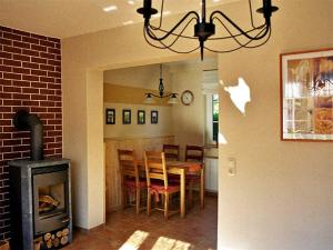a dining room with a table and a fireplace at Ferienwohnungen auf dem Lande in Kittendorf +8 photos
