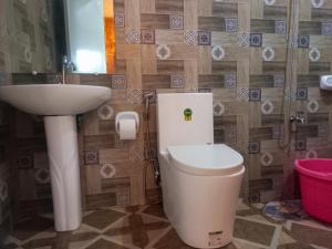 a bathroom with a toilet and a sink at Hidden Tourist Inn in Abu