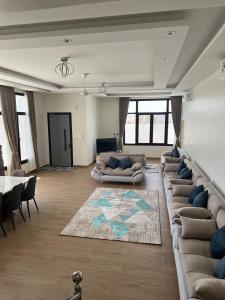 a large living room with couches and a table at Hills Villa in Sayq