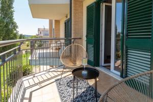 a patio with two chairs and a table on a balcony at Pescara INN al Golf - Tiger Woods in Miglianico