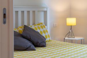 a bedroom with a bed with pillows and a lamp at Pescara INN al Golf - Tiger Woods in Miglianico