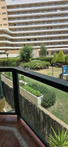 a balcony with a view of a large building at Apartamento Cozy Inns Beach in Torremolinos