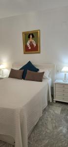a bedroom with a large white bed and two lamps at Apartamento Cozy Inns Beach in Torremolinos +16 photos