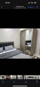 Una foto de un dormitorio con cama y espejo en Vokzal House, en Samarkand