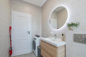 a bathroom with a sink and a washing machine at Charming 1 BD Apartment by Domvia in Kaunas +17 photos
