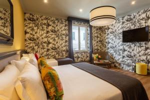 Postel nebo postele na pokoji v ubytování Boutique Hotel Hugo
