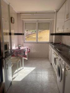 a small kitchen with a table and a sink at VUT Casa Albar in Soria +5 photos