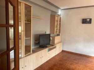 a living room with a flat screen tv on a shelf at VUT Casa Albar in Soria
