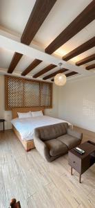 a bedroom with a bed and a couch at My Home 51-6 in Gongguan +19 photos