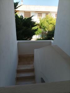 a view of a staircase in a white building at Dimora Relax in Torre dell'Orso
