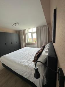 Ένα ή περισσότερα κρεβάτια σε δωμάτιο στο Appartement 'Zeeblick'