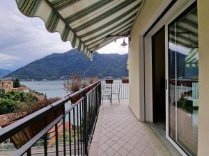 a balcony with a view of the water and mountains at Casa vacanze Flora con vista lago in Nesso