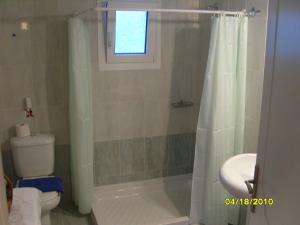 a bathroom with a shower and a toilet and a window at Elisabeth Villas in Kerveli +34 photos