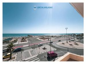 a view of a street with cars and the ocean at Ostia Holiday Al pontile 2 in Lido di Ostia