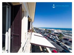 a balcony of a building with a view of a parking lot at Ostia Holiday Al pontile 2 in Lido di Ostia