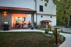 a group of people sitting on a patio at VIPAVA river house in Vipava