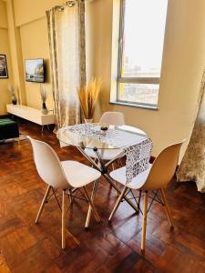 a dining room with a table and chairs and a window at Luxury Stay With Affordable Price in Johannesburg