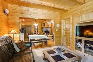 a living room with a couch and a table in a cabin at Cle Elum Mountain Cabin with Hot Tub and Hiking! in Cle Elum