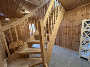 a staircase in a cabin with wooden walls at Koselig Gjestehus Med Badstue in Beitostøl +27 photos
