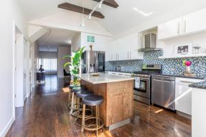 a kitchen with a wooden island with bar stools at Duplex 3 Bed 2 Bat Apt Steps from Lincoln Square in Chicago