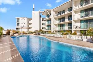 an image of a swimming pool in front of a building at Spa Retreat in Ballina +14 photos