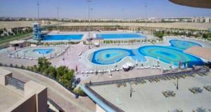 a large swimming pool in a resort at Comfy Relaxing Home in Madinaty in Madinaty