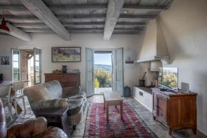 a living room with a couch and a table at Wp Relais Pompana Etruscan Villas in Villa Montesoli