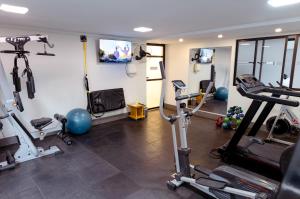 a gym with several treadmills and exercise bikes at Caitá Hotéis in Concordia