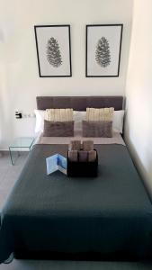 a bedroom with a large bed with a blue blanket at BEACH ALMIRANTE 9 MIJAS Marbella in Sitio de Calahonda +23 photos