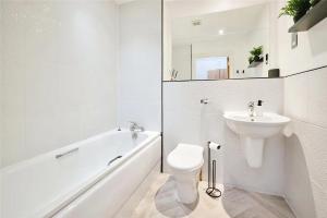 a white bathroom with a toilet and a sink at City Centre Apartment Jewellery Quarter in Birmingham +9 photos