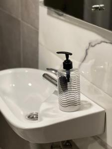 a soap dispenser sitting on top of a sink at Q tak in Sarajevo +9 photos