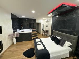 a bedroom with a king sized bed and a kitchen at SUITE Meghan home in Catania