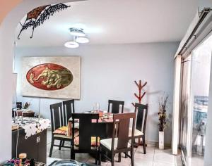 a dining room with a table and chairs and a dining room at La casa de Barbie Hermosa casa con alberca in Estrada +7 photos