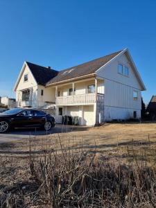 a house with a car parked in front of it at 1 etasje Jutulveien 6 in Tønsberg