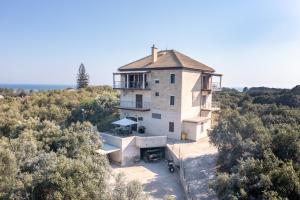 an aerial view of a house on a hill with trees at Melissa apartments 1 in Halikounas