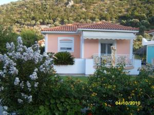 a house with a mountain in the background at Elisabeth Villas in Kerveli