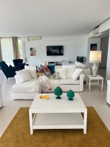a living room with white couches and a table at La Canostra Capri - luxury ROOM ad Anacapri in Anacapri