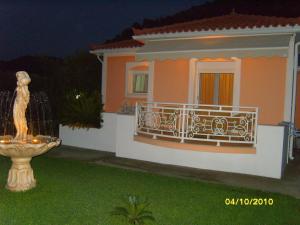 a house with a statue in the front yard at Elisabeth Villas in Kerveli