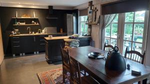 a kitchen with a wooden table and a kitchen with a sink at Kouwenberg in Aarle-Rixtel