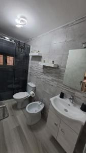 a bathroom with a toilet and a sink and a mirror at Casa Gioele in Siracusa +16 photos