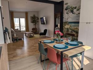 a dining room and living room with a table and chairs at Le SPA - Villa Valmy - Hypercentre - Gare SNCF in Montluçon +17 photos