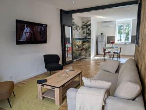 a living room with a couch and a table at Le SPA - Villa Valmy - Hypercentre - Gare SNCF in Montluçon