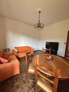 a living room with a table and a couch at Daddy's house - maximum car length allowed 420cm in Genova