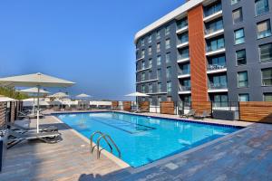 a large swimming pool in front of a building at Caddem Inn Hotel in Famagusta