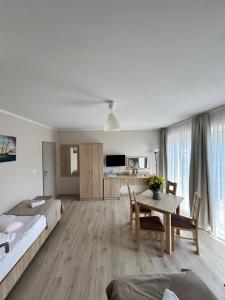 a bedroom with a bed and a table in a room at Dom Gościnny Stokrotka in Pustkowo