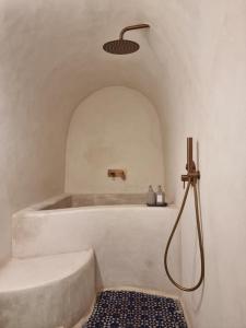 a bathroom with a bath tub with a shower head at Casa Amina in Chefchaouene