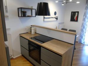 a kitchen with a counter top and a stove at Appartamento Nicole in Ravascletto