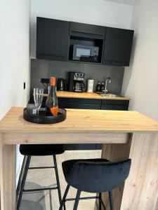 a kitchen with a wooden table with two bar stools at A7 Apartment 2 in Dätgen