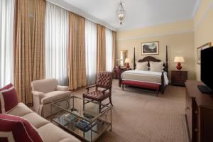 a hotel room with a bed and a couch at Capital Hotel in Little Rock